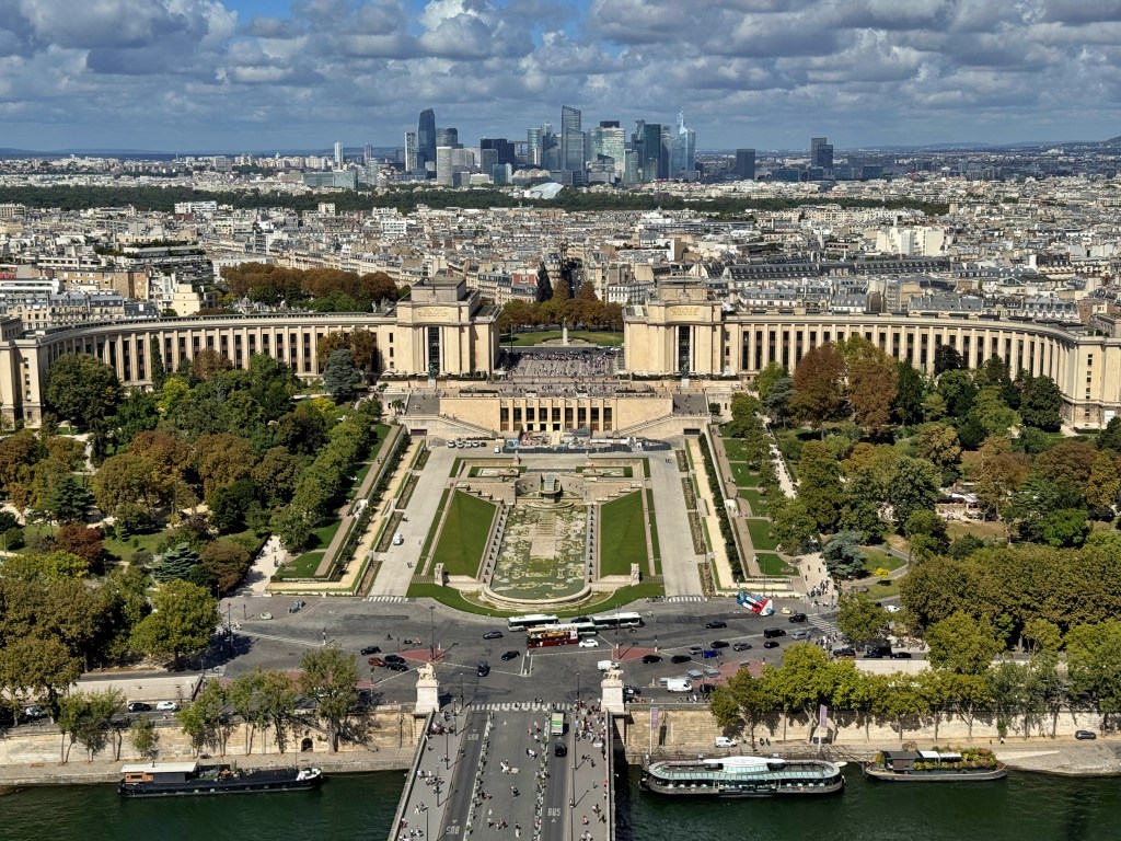 Aerial view of the Palais de Chaillot and Trocadero gardens in Paris with the city skyline in the background
